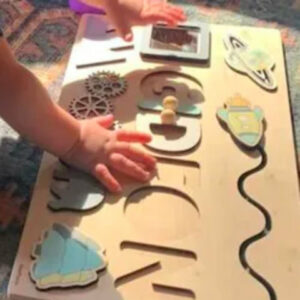 a child using the custom name montessori wooden board