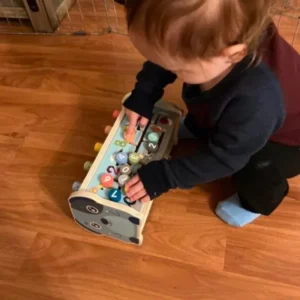 a grandson playing with the educational whack-a-mole