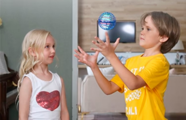 two kids playing with the flying led lights magic ball