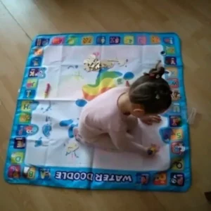 a granddaughter drawing on the magic mat