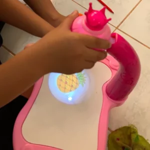 a granddaughter using the led art painting table projector