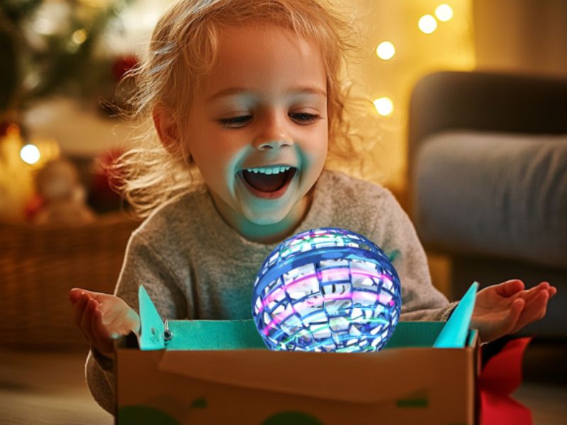 Grandparent and child smiling under a softly glowing toy at dusk