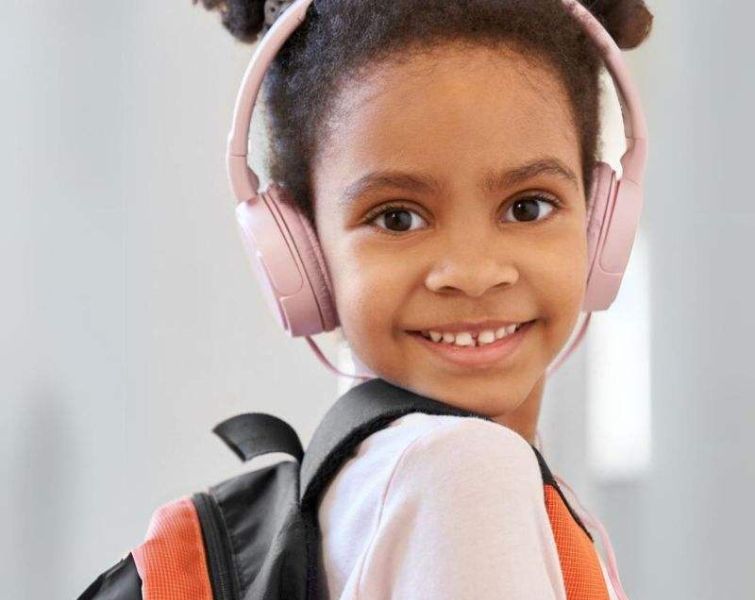 Little girl playing with MP3 Player with headset