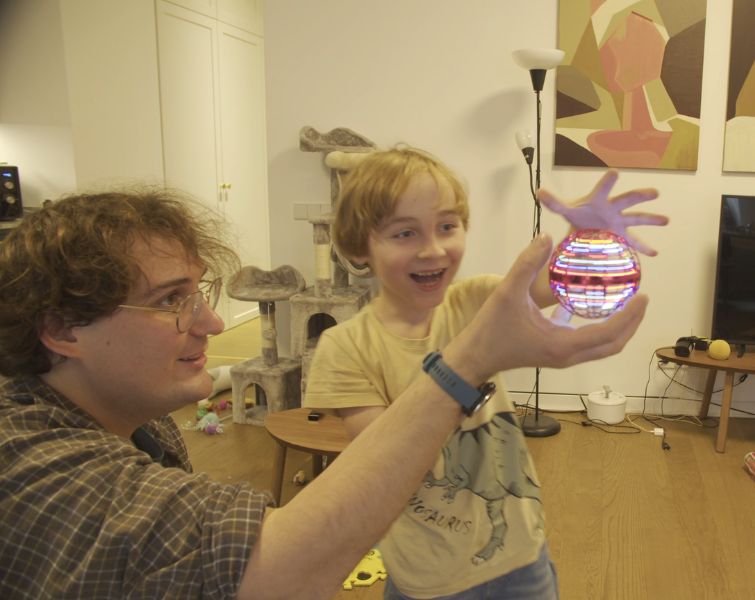 Happy family playing with flying LED ball