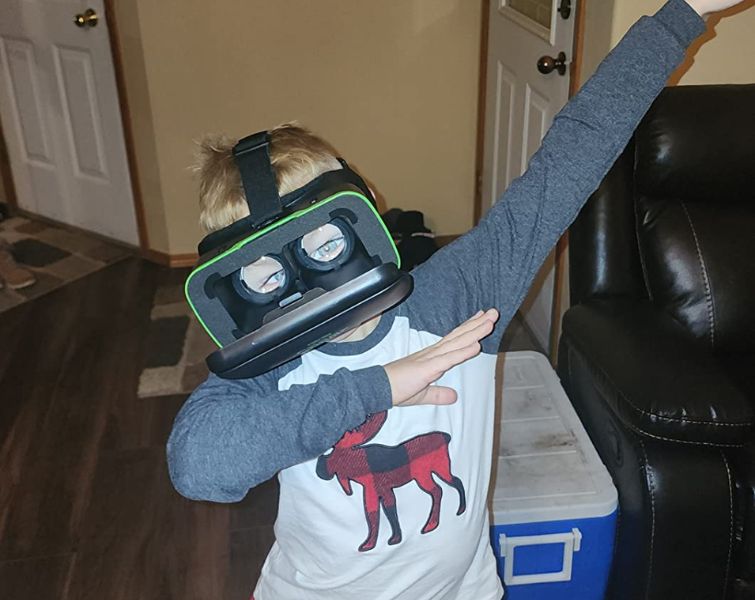 Happy kid playing with VR set