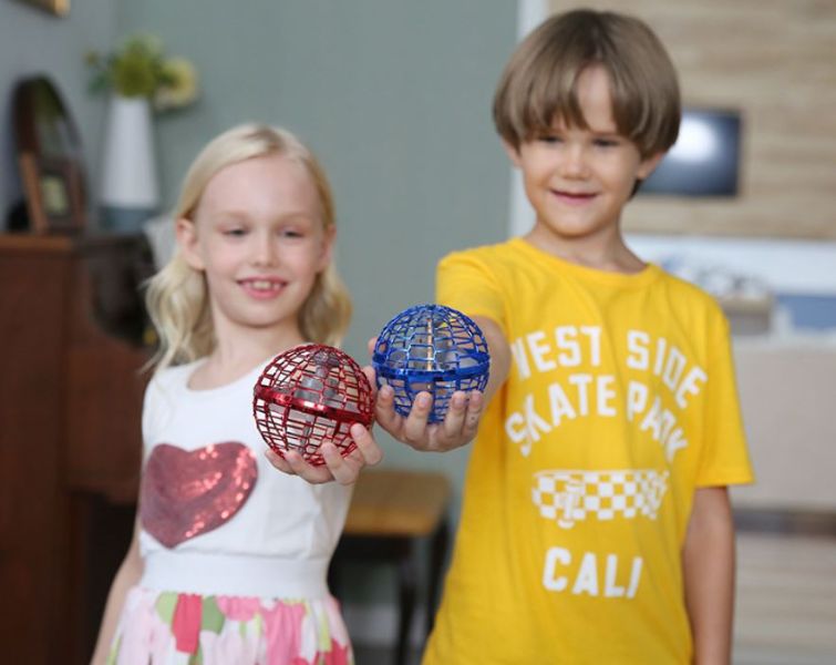 Happy kids playing with galaxy flying LED