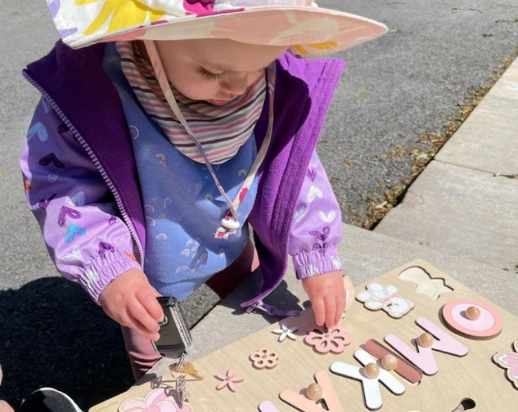 Little baby playing with custom Montessori board