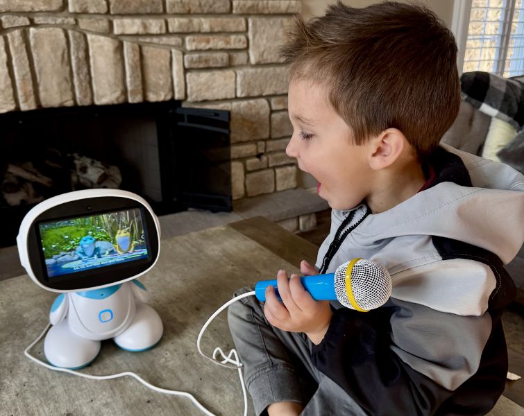 Little boy playing with AI Robot