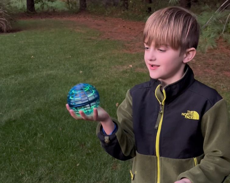 Little boy playing with flying ball