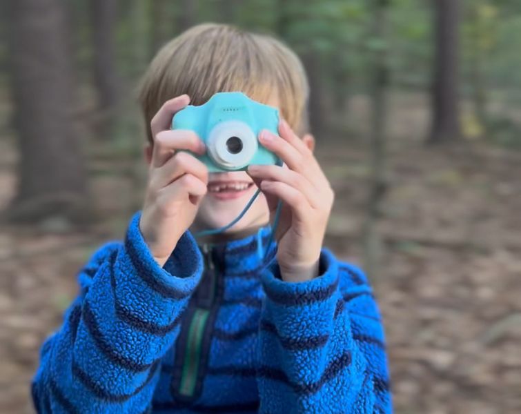Little boy playing with LittleLens camera