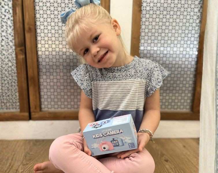Little girl holding LittleLens camera