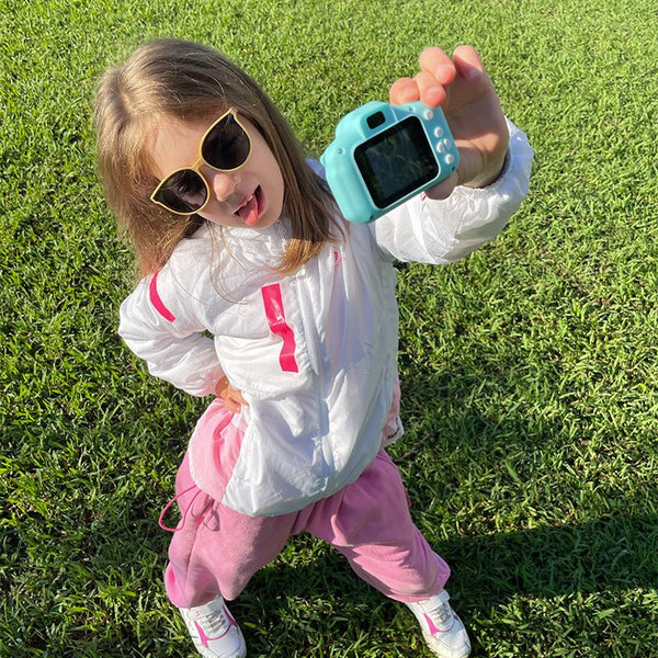 Child holding the LittleLens Kids Camera outdoors