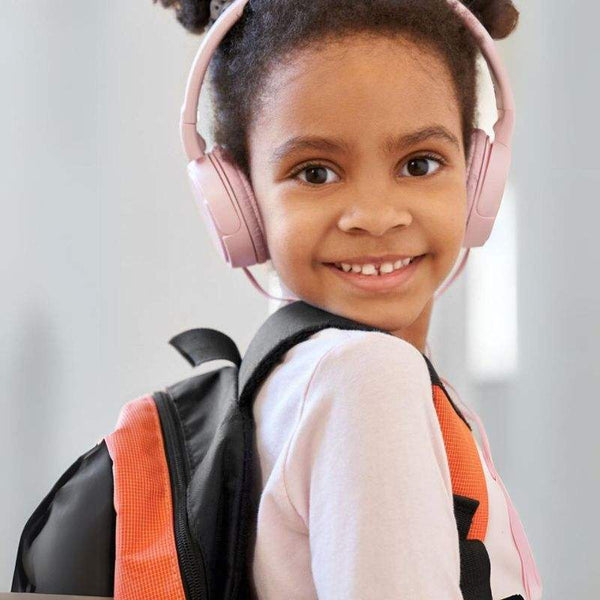 Child wearing pink headset and backpack with MP3 player